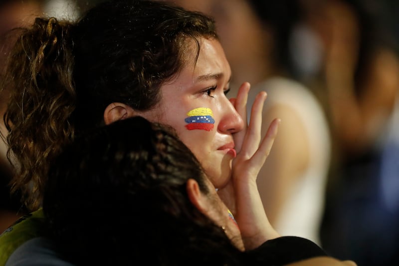 Una ciudadana venezolana llora tras conocer los resultados del primer boletín oficial de las elecciones presidenciales, este domingo a las afueras de la Embajada de Venezuela en Ciudad de Panamá