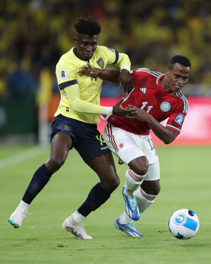 Ecuador's Jhoanner Chavez, left, and Colombia's Jhon Arias, battle for the ball during a qualifying soccer match for the FIFA World Cup 2026 at the Rodrigo Paz Delgado stadium in Quito, Ecuador, Tuesday, Oct. 17, 2023. (AP Photo/Patricio Teran)