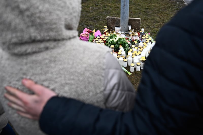 La gente se encuentra frente a un monumento improvisado tras un tiroteo en Suecia